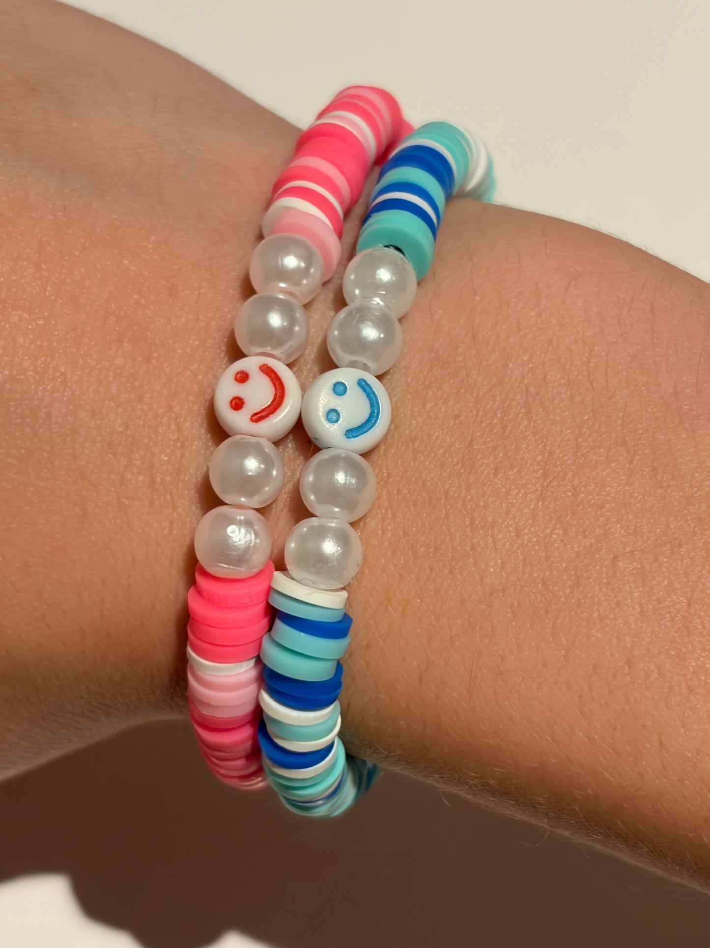 Two set of cute smiley face bracelets (pink and blue)